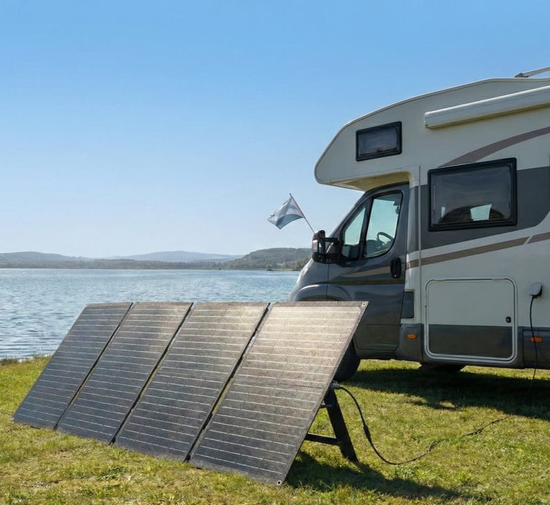 Sola-E foldable solar panel spread out on outdoor grass for RV camping power generation.