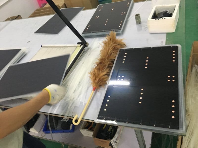 Post-processing and edge trimming of a finished OEM small solar panel for remote monitoring devices.