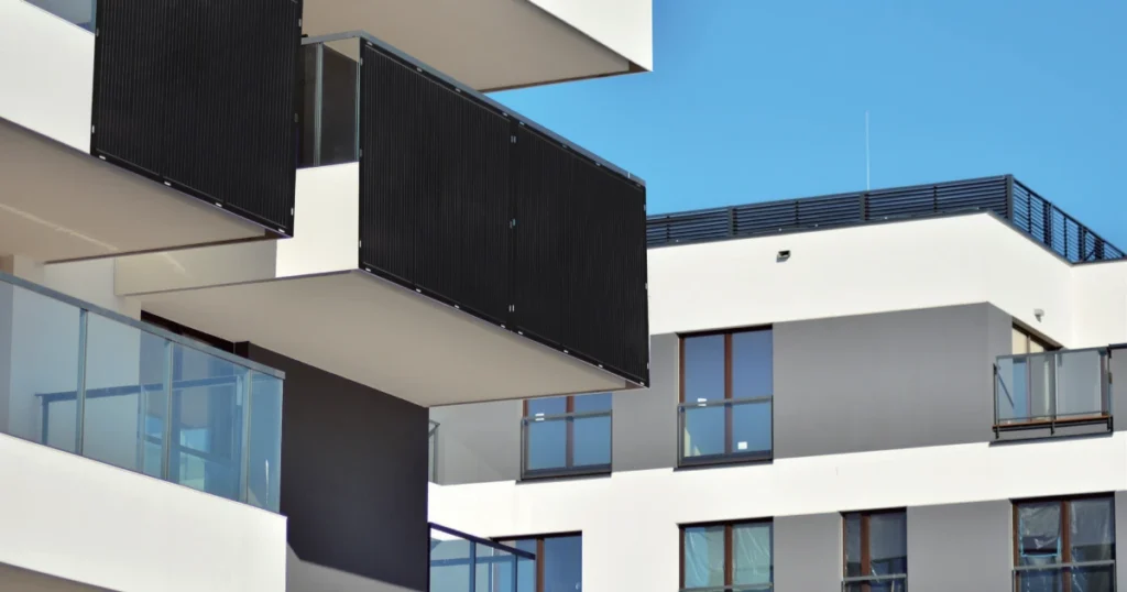 Flexible ETFE solar panel system with micro-inverter installed on a US apartment balcony using non-invasive mounting methods.