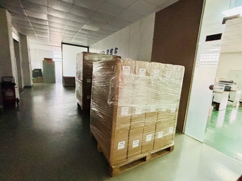 Flexible solar panel cartons staged for container loading